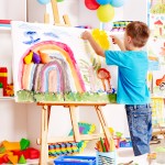 Child painting at easel.